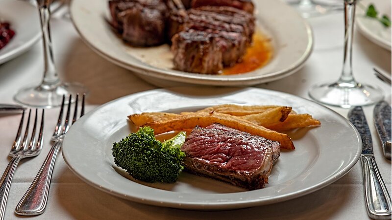 Steak entree with side of french fries and broccoli